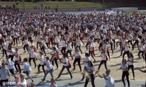 Group In White Shirts Dancing In Field GIF