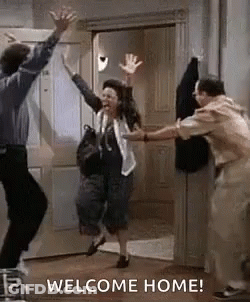 Group Jumping In Front Of Welcome Home Door GIF