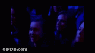 Group Laughing Together In Dark Room GIF