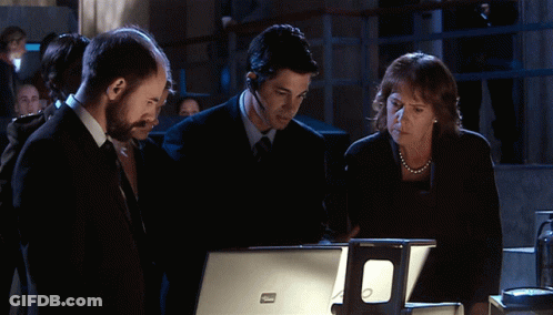 Group Looking At Dell Laptop GIF