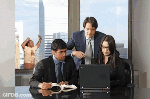Group Looking At Laptop With Man In T-Shirt Behind GIF