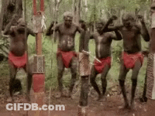 Group Of Aboriginal Men Dancing In The Woods GIF