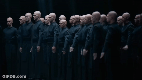 Group Of Bald Men Standing In Dark Room GIF