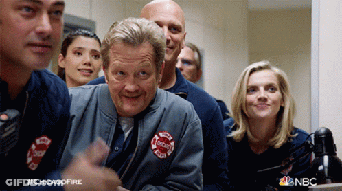Group Of Chicago Firefighters Around Table GIF