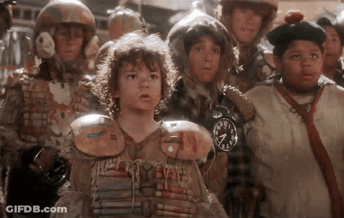 Group Of Children In Line One Holding Clock At 7:00 GIF
