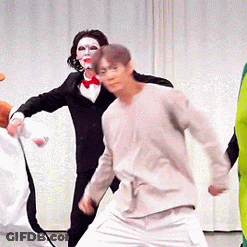 Group Of Costumed People Dancing GIF
