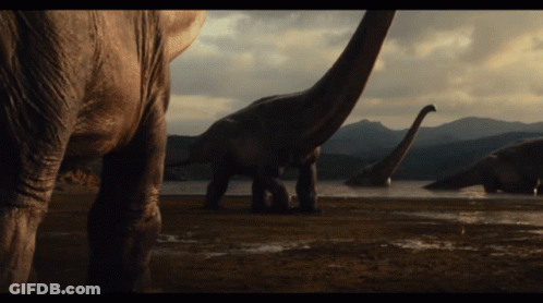 Group Of Dinosaurs Near Lake GIF