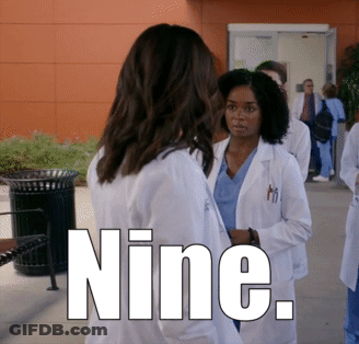 Group Of Doctors Standing Outside Building Saying Nine GIF