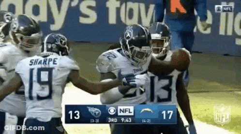 Group Of Football Players Holding Ball On Field GIF