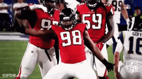 Group Of Football Players Standing On Field GIF