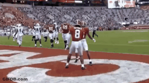 Group Of Football Players Standing On Field GIF
