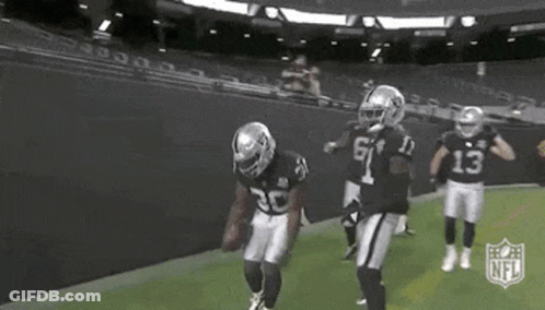 Group Of Football Players Standing On Field GIF