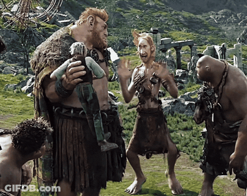 Group Of Giants Standing In Grassy Area GIF
