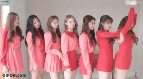 Group Of Girls In Red Dresses Standing In Line GIF