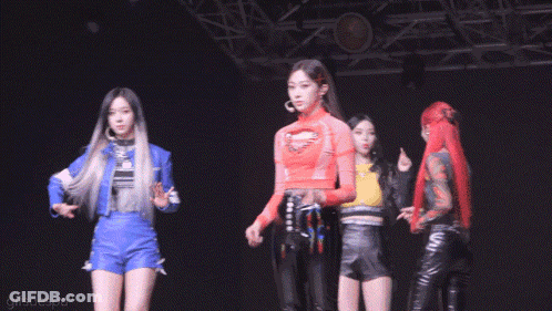 Group Of Girls On Stage With Man Between Them GIF