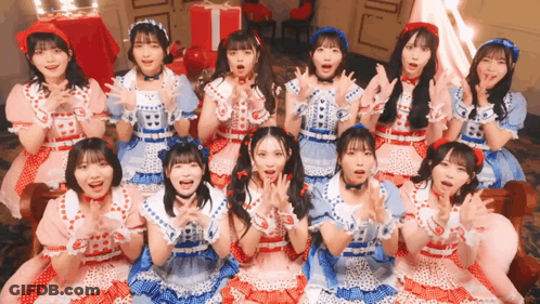 Group Of Girls Posing, One In Red Hat GIF