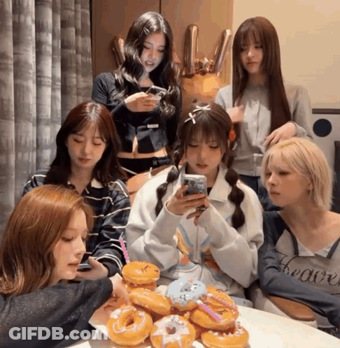 Group Of Girls Sitting Around Table With Donuts GIF