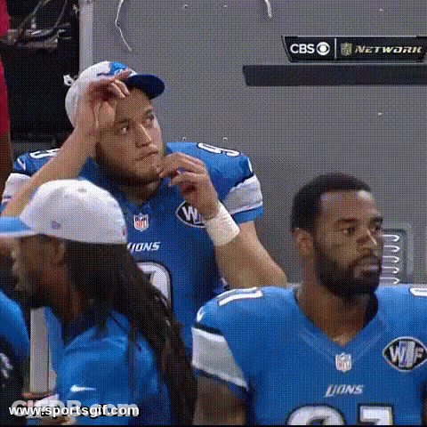 Group Of Lions Football Players Sitting In Locker Room GIF