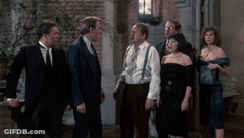Group Of Men And Women Standing In Front Of Brick Wall GIF