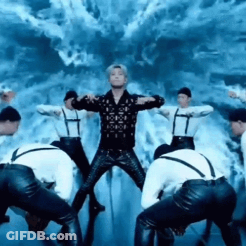 Group Of Men Dancing On Stage With Man In Middle GIF