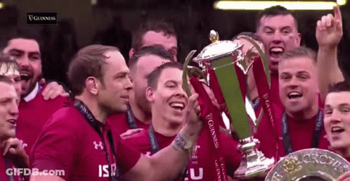 Group Of Men Holding Guinness Trophy GIF