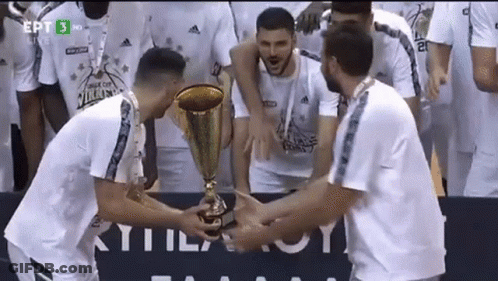 Group Of Men Holding Trophy In Front Of EPT Sign GIF