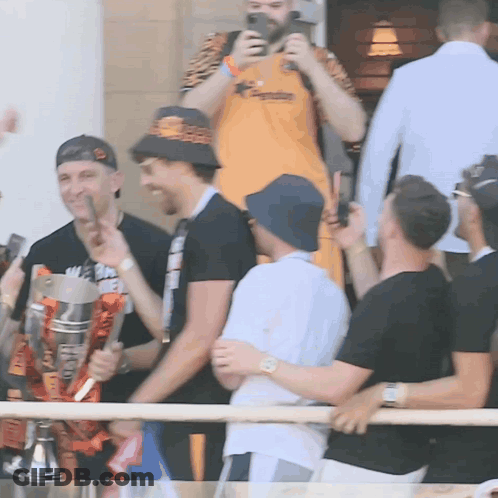 Group Of Men Holding Trophy Saying A GIF