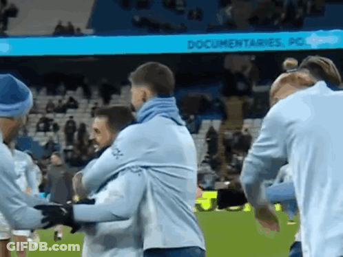 Group Of Men Hugging On Soccer Field Saying Documentaries GIF