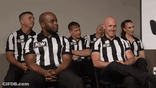 Group Of Men In AEW Striped Shirts Sitting In Row GIF