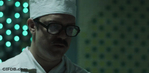 Group Of Men In Dark Room Saying It's Pronounced Jiff GIF