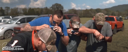 Group Of Men In Field One Wearing J. J. Jergens Shirt GIF