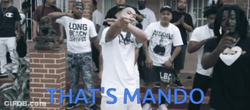 Group Of Men In Front Of Brick Building Saying That's Mando GIF