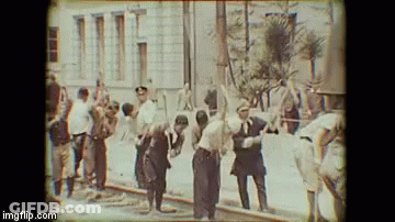 Group Of Men In Front Of Building GIF