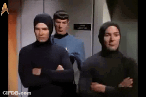 Group Of Men In Hooded Suits GIF