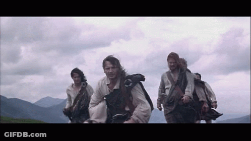 Group Of Men In Kilts Walking In Line GIF