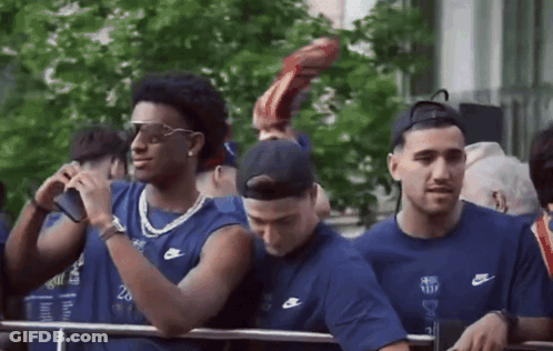 Group Of Men In Nike Shirts Standing In Line GIF