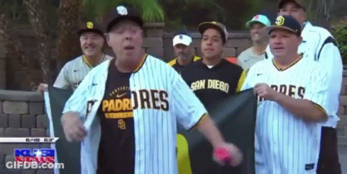 Group Of Men In Padres Jerseys In Front Of Brick Wall GIF