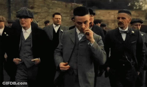 Group Of Men In Suits And Hats Walking GIF