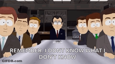 Group Of Men In Suits Around Table With Man Standing GIF