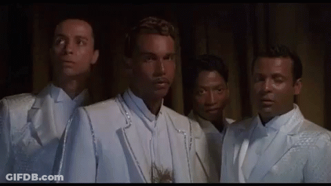 Group Of Men In White Suits And Ties Standing Together GIF