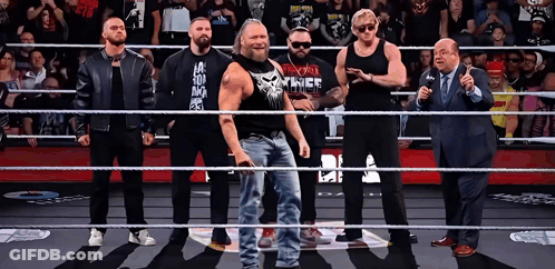 Group Of Men In Wrestling Ring, One Wearing The Punisher Shirt GIF