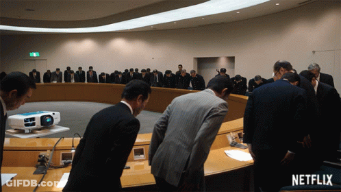 Group Of Men Kneeling In Front Of Projector Netflix Sign GIF