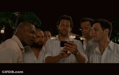 Group Of Men Looking At Phone Together GIF