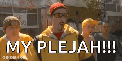 Group Of Men On Street One Wearing Sunglasses And Hat GIF