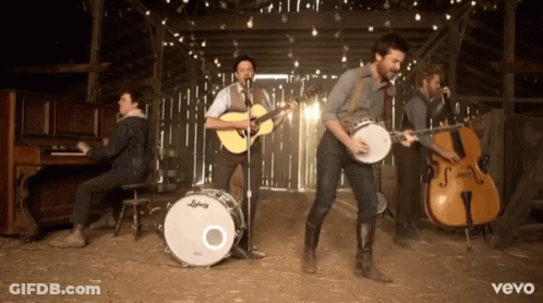 Group Of Men Playing Instruments In Barn With Vevo GIF