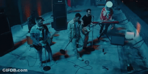 Group Of Men Playing Instruments On Stage GIF