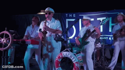 Group Of Men Playing Instruments Under The Fifth Banner GIF