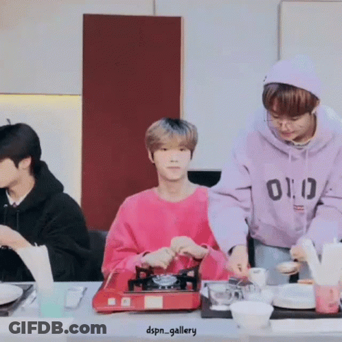 Group Of Men Preparing Food At Table GIF