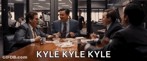 Group Of Men Sitting Around Table Saying Kyle Kyle Kyle GIF