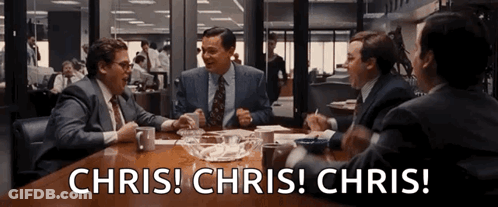 Group Of Men Sitting Around Table With Chris Chris Chris GIF